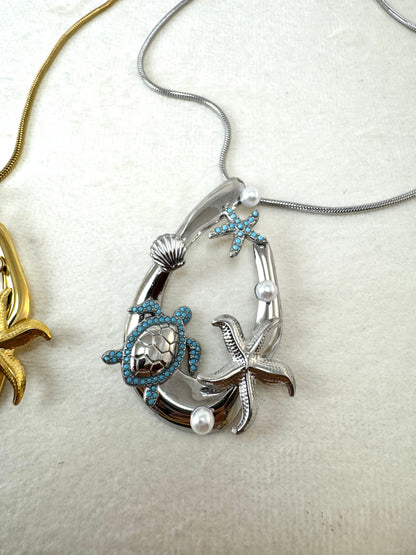 Collana lunga con ovale e ciondoli marini
